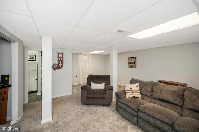 living area featuring baseboards, visible vents, a paneled ceiling, and light colored carpet