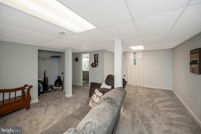 basement with baseboards, visible vents, carpet floors, and a paneled ceiling