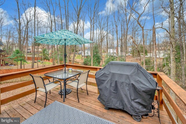 deck featuring area for grilling and outdoor dining area