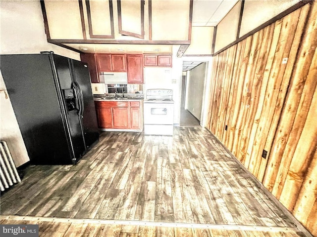 kitchen featuring brown cabinets, dark wood-type flooring, black refrigerator with ice dispenser, white electric range, and a sink