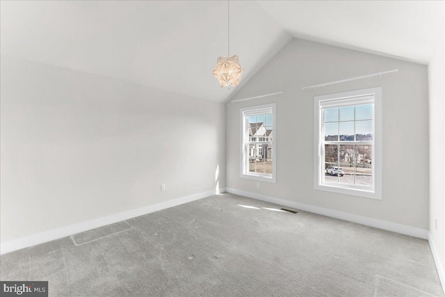 interior space featuring baseboards, visible vents, vaulted ceiling, and carpet flooring