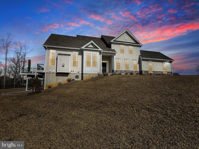 view of front of home featuring ac unit, a lawn, and a deck