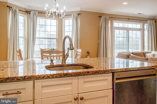 kitchen with light stone countertops, ornamental molding, stainless steel dishwasher, and a sink