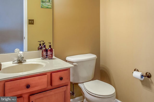 bathroom featuring toilet and vanity