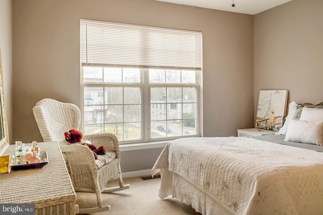 carpeted bedroom featuring visible vents and baseboards