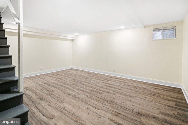 basement with recessed lighting, stairway, baseboards, and wood finished floors