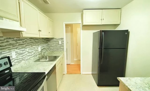 kitchen featuring appliances with stainless steel finishes, a sink, white cabinetry, and under cabinet range hood