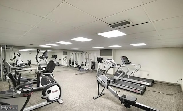 gym featuring a paneled ceiling and visible vents