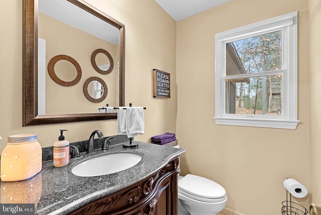 half bath featuring toilet and vanity