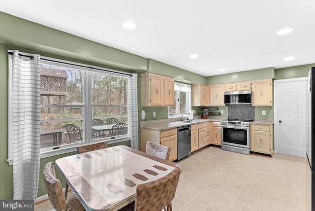 kitchen with stainless steel appliances, recessed lighting, light brown cabinets, and a sink