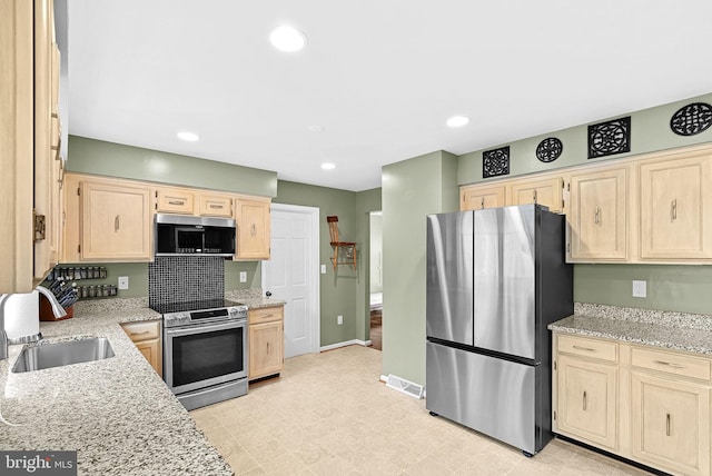 kitchen with recessed lighting, a sink, visible vents, appliances with stainless steel finishes, and light brown cabinetry