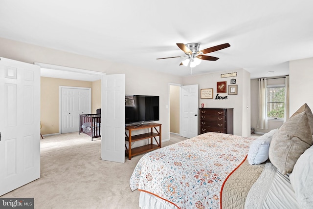 bedroom featuring baseboards, a ceiling fan, and light colored carpet