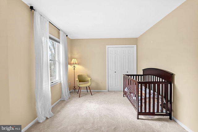 bedroom with carpet floors, baseboards, and a closet