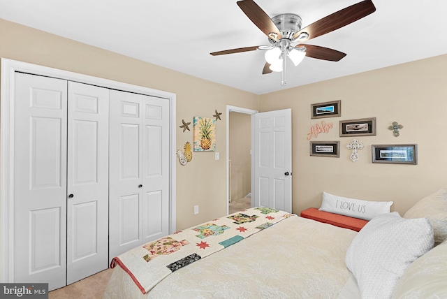 carpeted bedroom with a ceiling fan and a closet