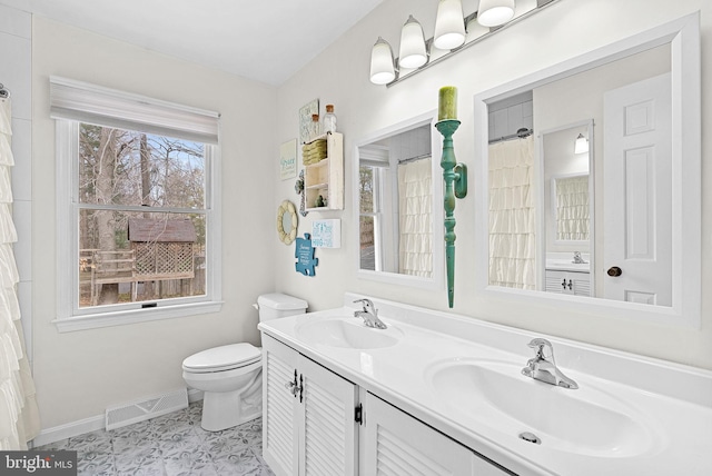 full bathroom featuring toilet, baseboards, visible vents, and a sink