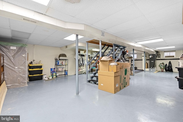 below grade area featuring stairway, a drop ceiling, and visible vents