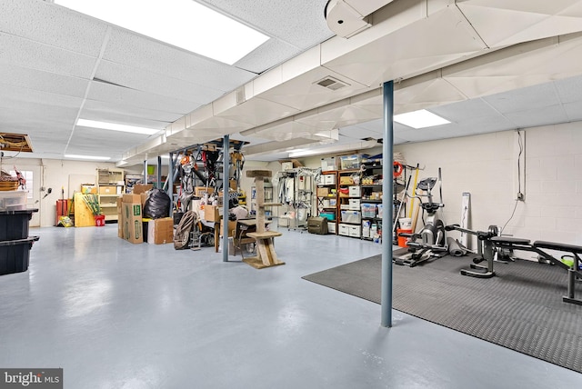 interior space with visible vents and concrete block wall