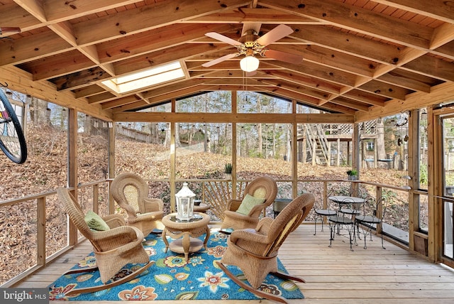 unfurnished sunroom with lofted ceiling with skylight and ceiling fan