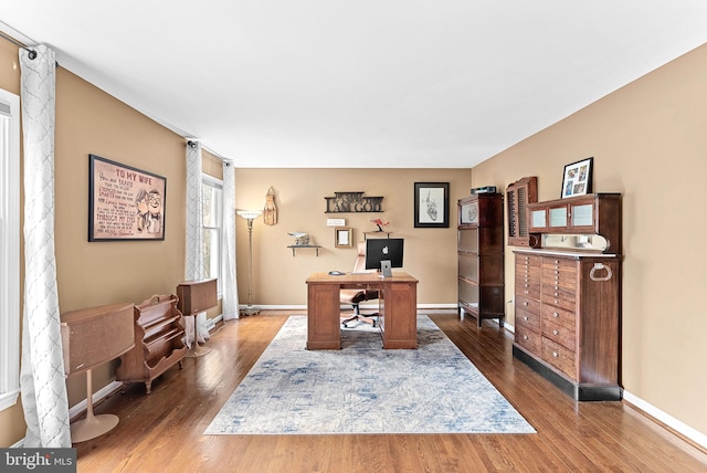 office space with dark wood-type flooring and baseboards