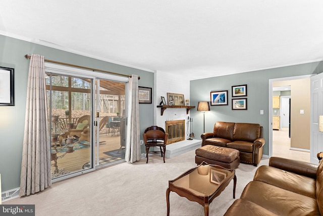 living area featuring carpet floors, ornamental molding, a fireplace, and baseboards