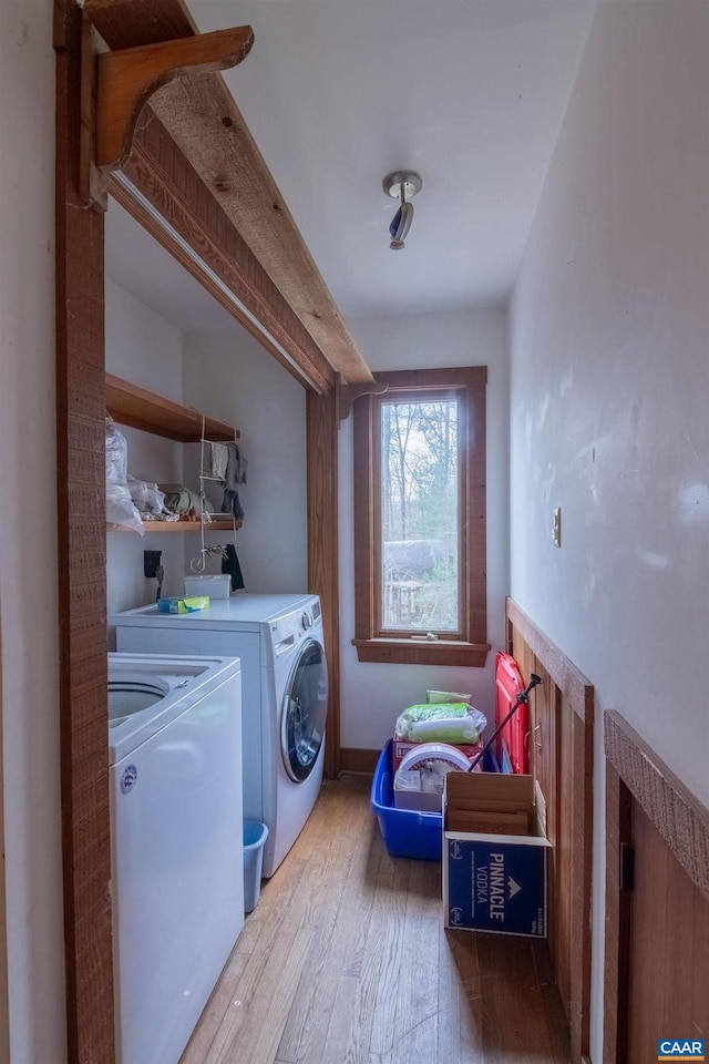 laundry room with washing machine and dryer and hardwood / wood-style floors