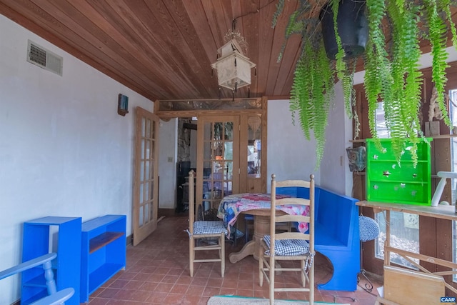 dining room featuring wooden ceiling, tile patterned floors, visible vents, and french doors