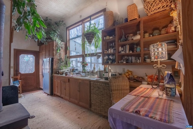 kitchen featuring a sink and freestanding refrigerator