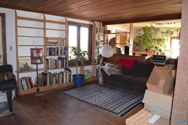 living area featuring wooden ceiling, wood finished floors, and a wood stove