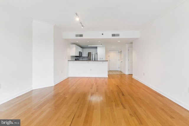 unfurnished living room with light wood-type flooring, visible vents, and crown molding