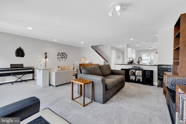 living room with recessed lighting, light carpet, beverage cooler, visible vents, and baseboards