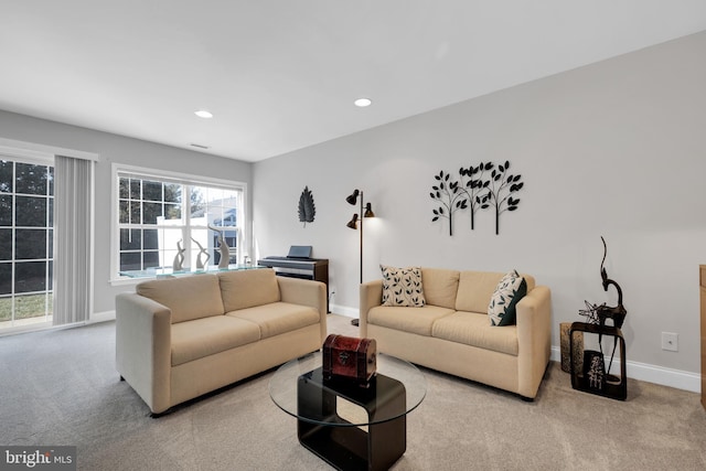 carpeted living room with recessed lighting and baseboards