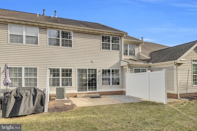 back of property featuring a yard, a patio area, and fence