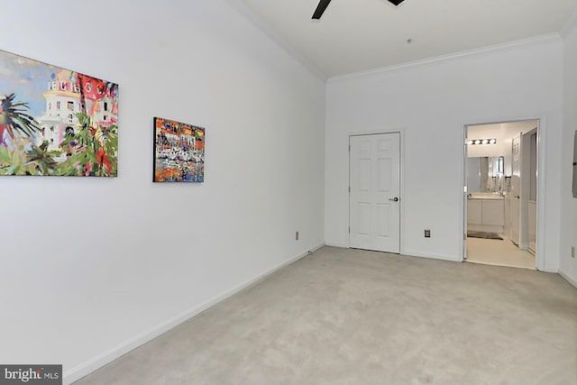 unfurnished bedroom featuring ornamental molding, carpet, ensuite bath, and baseboards