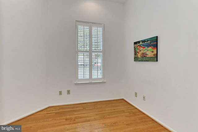 spare room with light wood-type flooring and baseboards