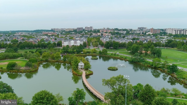 birds eye view of property featuring a water view and a city view