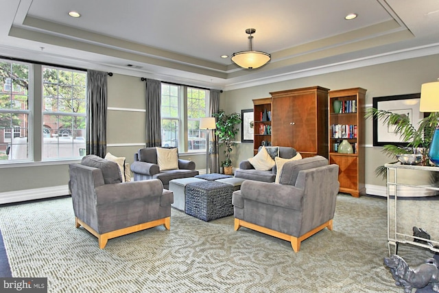 carpeted living area featuring recessed lighting, a raised ceiling, and baseboards