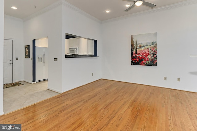 empty room with baseboards, a ceiling fan, crown molding, light wood-style floors, and recessed lighting