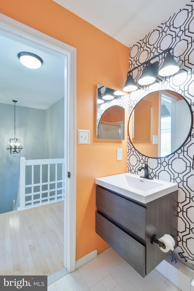 bathroom with vanity and an inviting chandelier