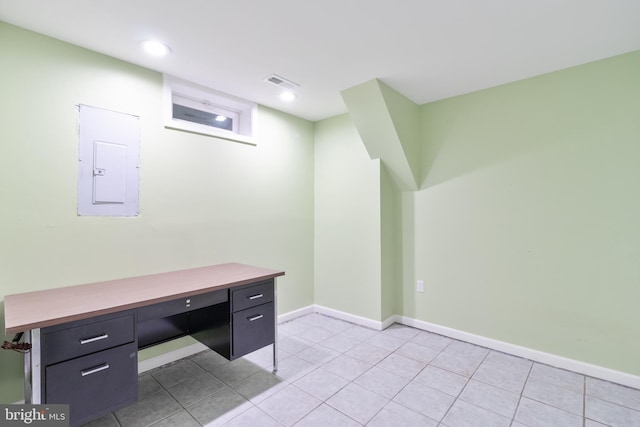 home office with light tile patterned floors, baseboards, electric panel, and visible vents