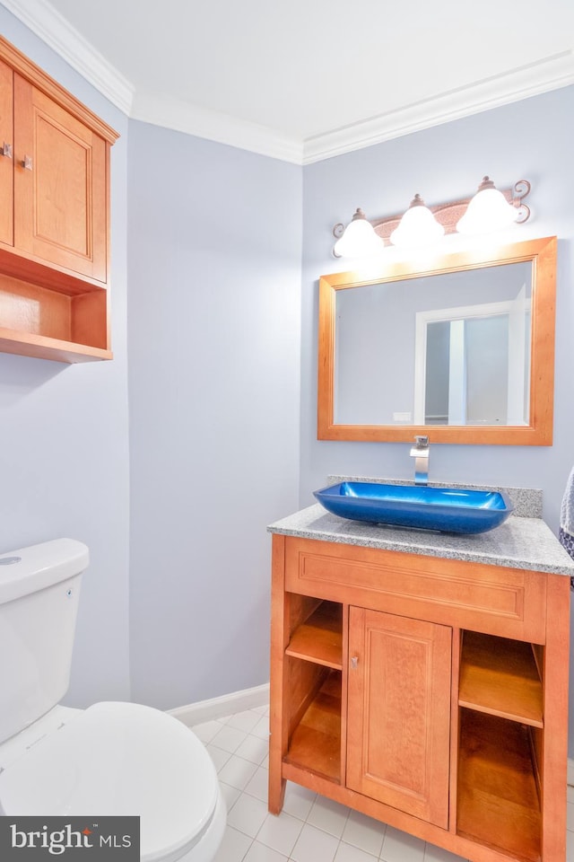 half bathroom featuring tile patterned flooring, crown molding, vanity, and toilet