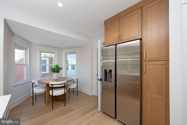 dining space featuring recessed lighting, baseboards, and light wood finished floors