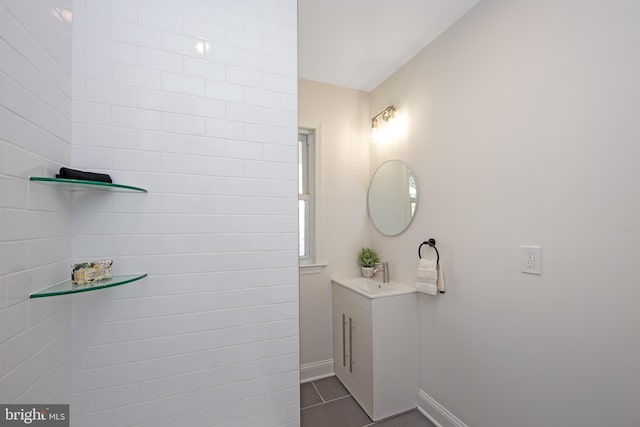 bathroom featuring tile patterned flooring, baseboards, and vanity