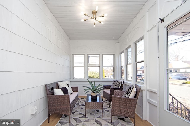 sunroom featuring a chandelier