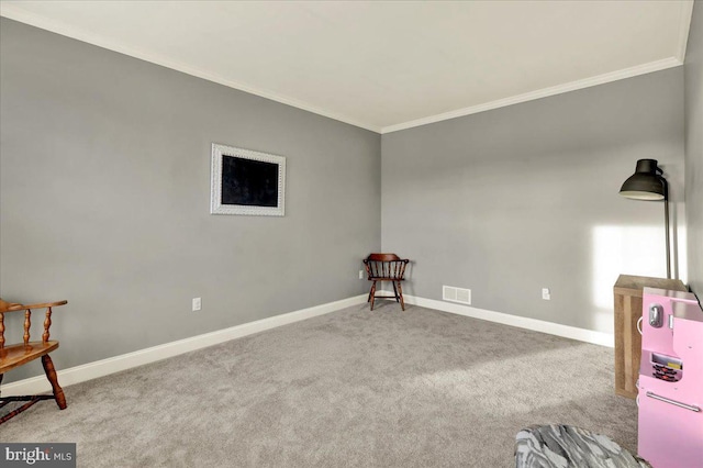 living area featuring baseboards, visible vents, ornamental molding, and light colored carpet