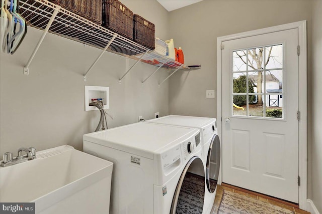 laundry room featuring laundry area, a sink, and washing machine and clothes dryer