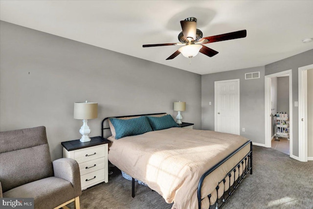 bedroom with ceiling fan, dark carpet, visible vents, and baseboards