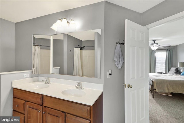 full bathroom with double vanity, curtained shower, a sink, and ensuite bathroom