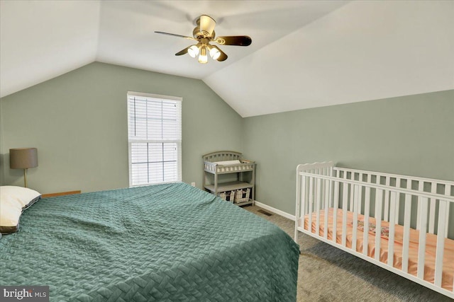 bedroom with visible vents, carpet flooring, vaulted ceiling, ceiling fan, and baseboards