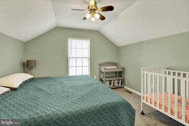 bedroom with lofted ceiling, visible vents, carpet flooring, ceiling fan, and baseboards