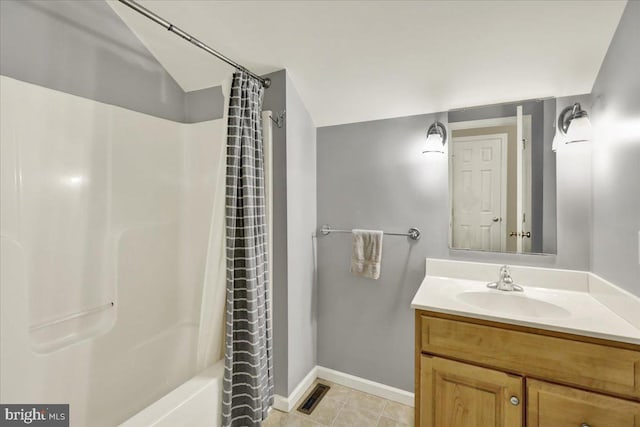 full bath with visible vents, shower / tub combo, vanity, tile patterned flooring, and baseboards